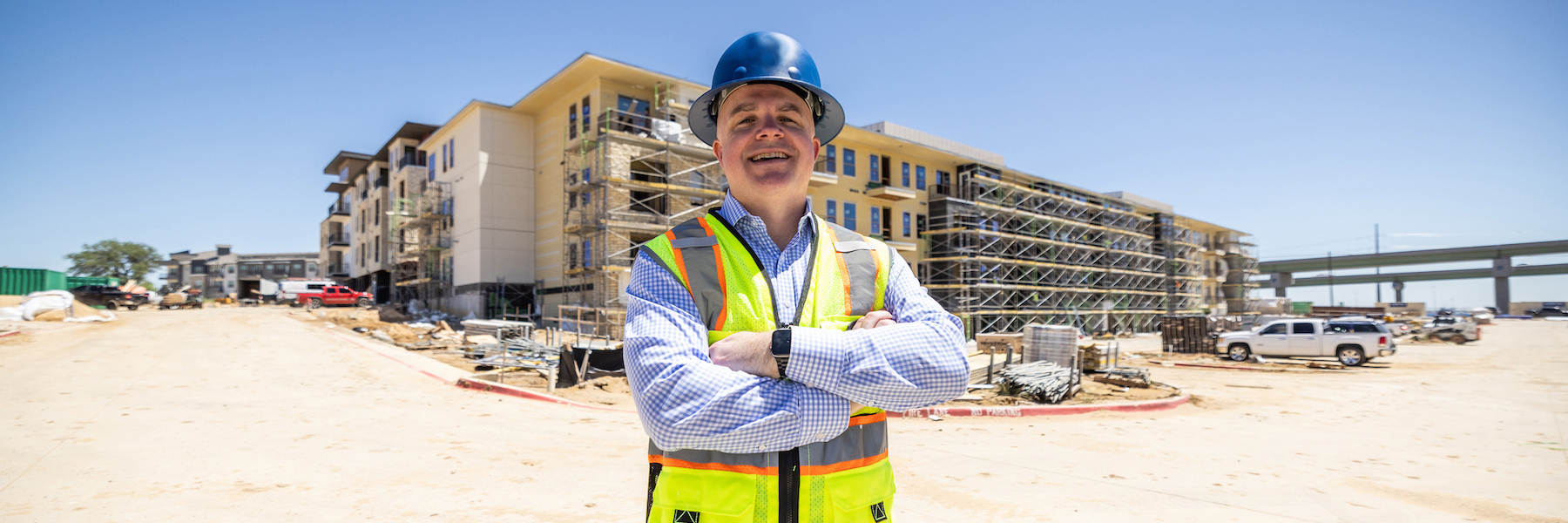 Payton Mayes in hardhat outside of building