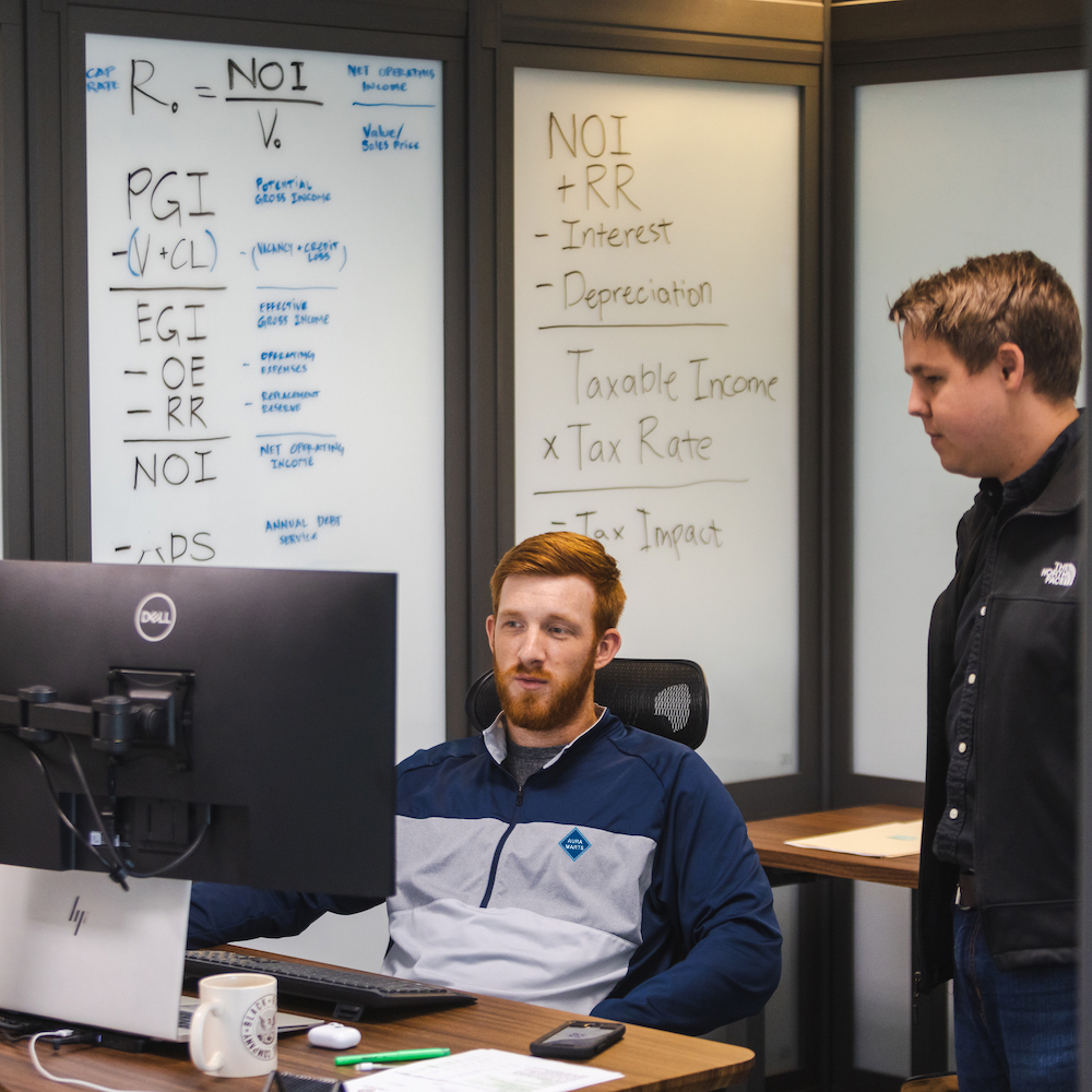 JPI associates reviewing laptop together