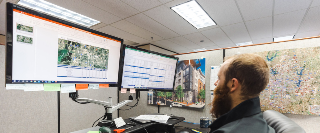 JPI associate working on plans and renderings on computer